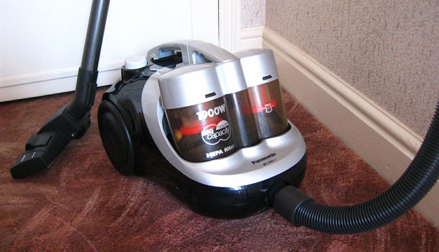 A cylinder vacuum cleaner on a carpet